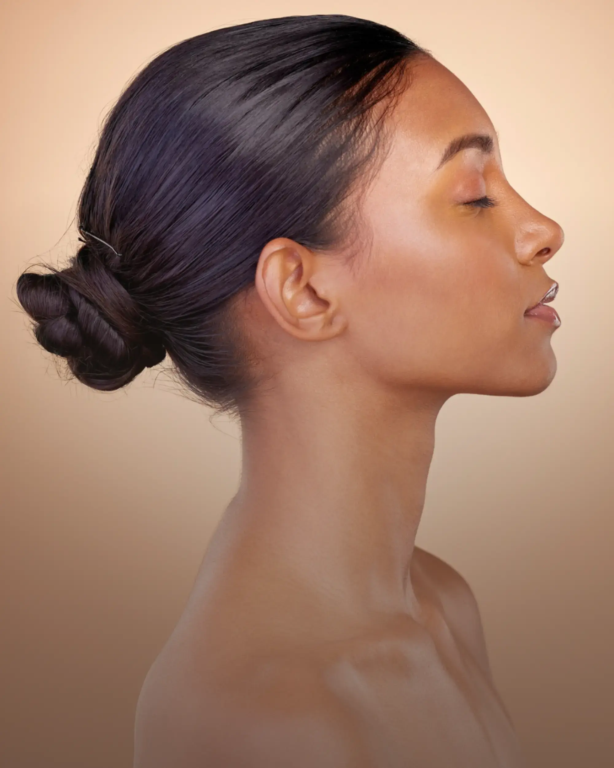 a-side-headshot-image-of-black-lady-with-a-pony-tail-the-head-turned-right-with-beautifull-skin